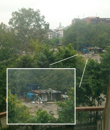 A makeshift dwelling across from a $200/night hotel. There were freshly-washed clothes on the clothes line the next morning.